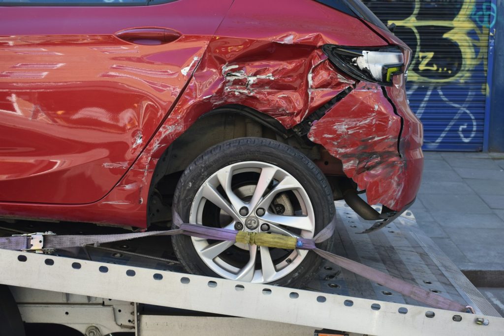 Rideshare Accident Lawyer in Bellerose – damaged car on a tow truck