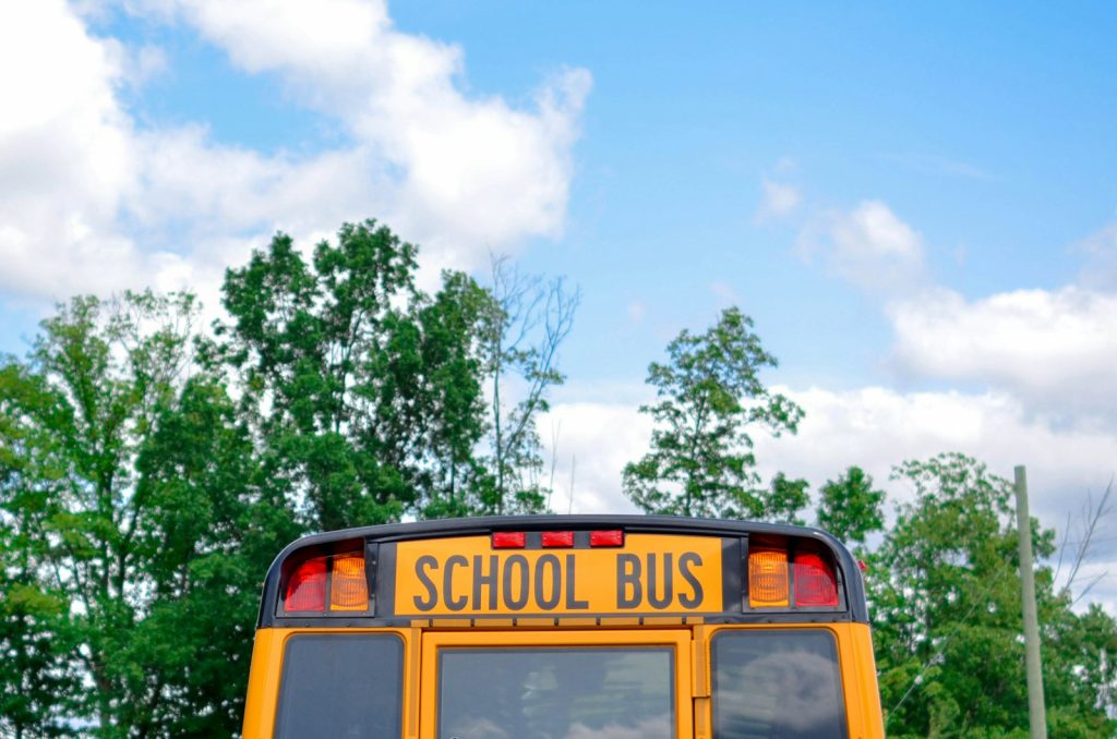School Bus Accident Lawyer in Bellerose – school bus near trees on a residential road