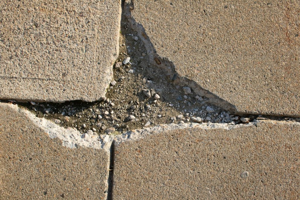 Trip and Fall Accident Lawyer in Bellerose – crack in a concrete sidewalk