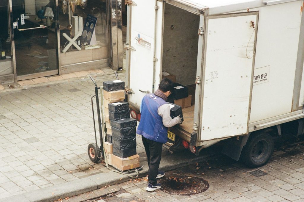 Workplace Accident Lawyer in Bellerose – worker loading boxes from a vehicle